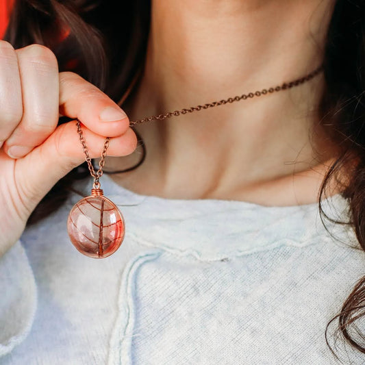 Close up of white girl wearing a 17" Copper Chain with a pink leaf glass pendant