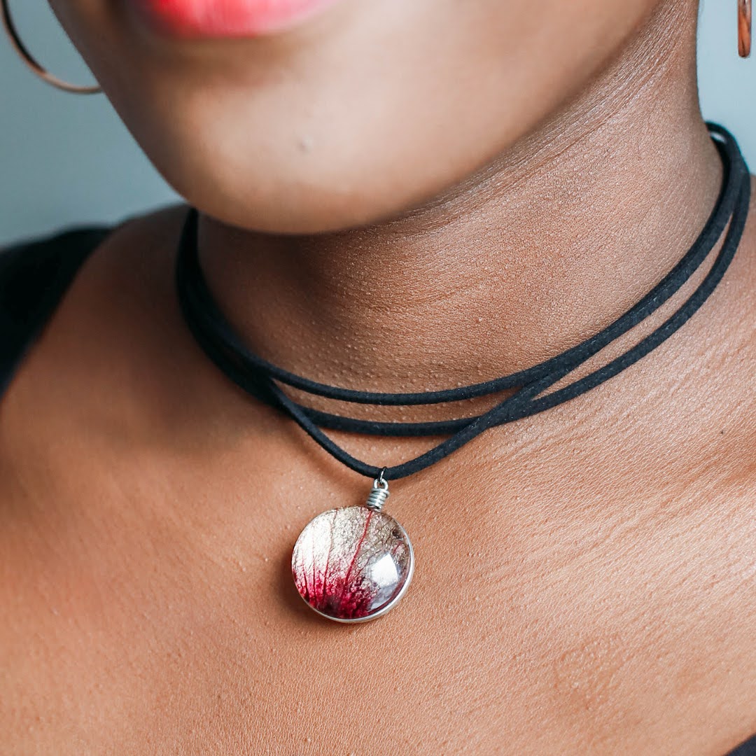 Close up of Black girl wearing a flower petal glass pendant on a 13" Stacked Faux Leather Choker