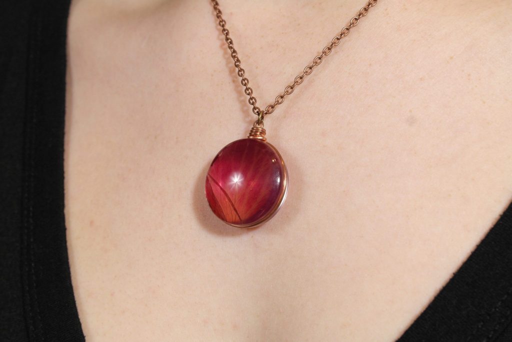Close up of Rose Petal Pendant being worn with a copper chain