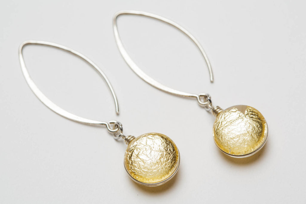 Gold Sungold Dangle Earrings on a white background